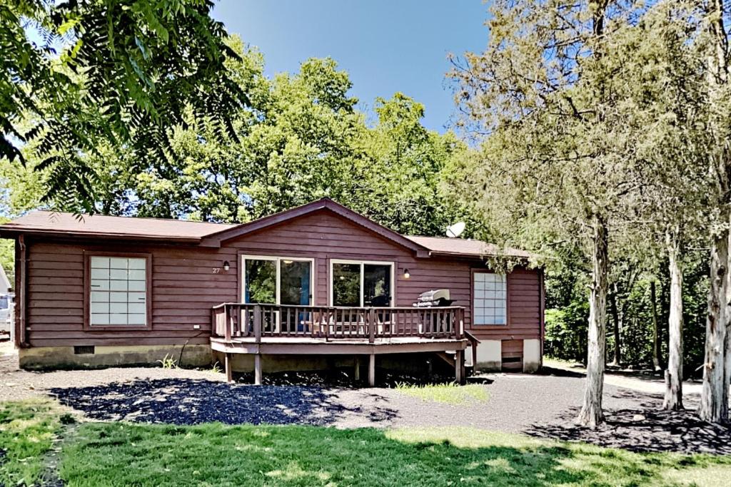 a log cabin with a porch and a deck at Island Club #27 in Put-in-Bay