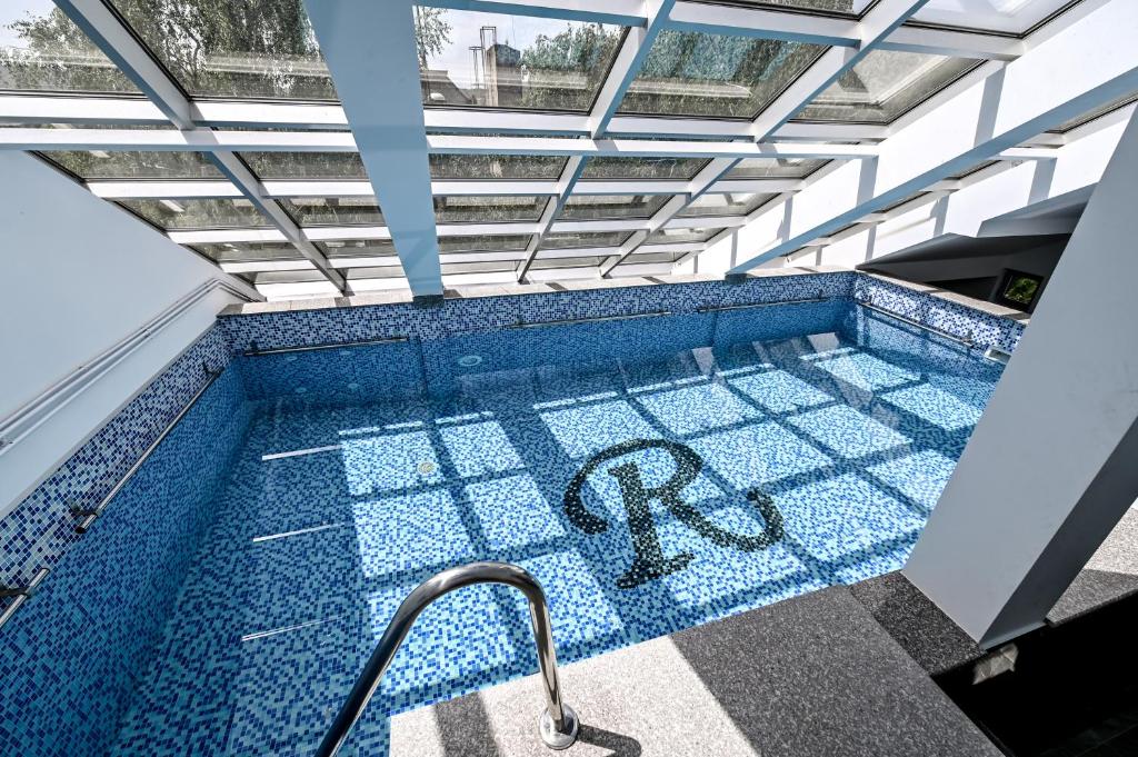 a swimming pool with a handrail in the middle at Respect034 in Arandelovac