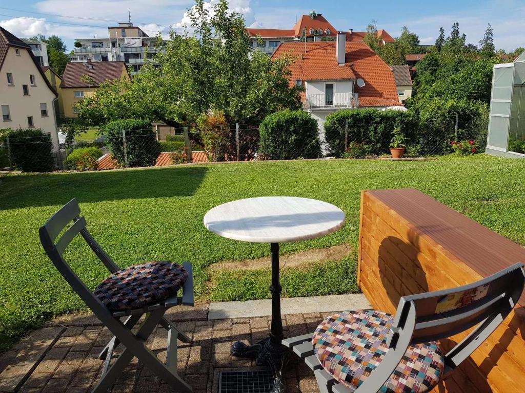 a table and two chairs on a patio with a table at Charlottenhöhe Apartment in Rottweil