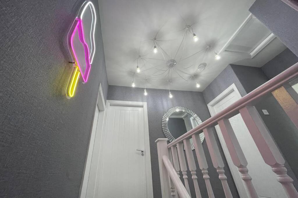 a room with a staircase with a pink butterfly on the wall at Viva La Brid in Bridlington