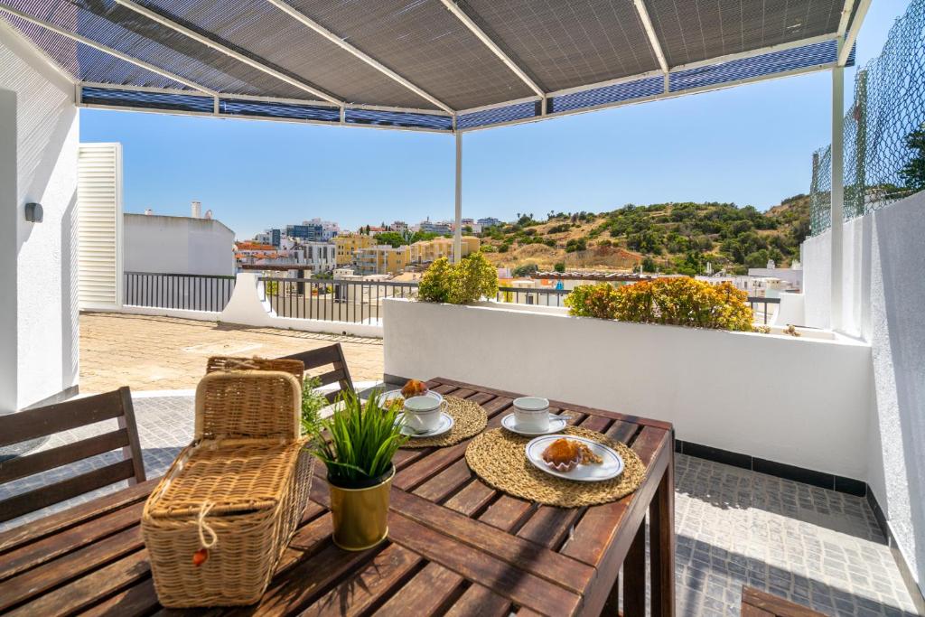 een tafel en stoelen op een balkon met uitzicht bij Charming Blue Albufeira in Albufeira