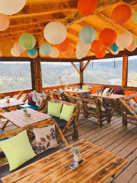 a restaurant with tables and chairs on a boat at Avlija Biberović in Sjenica