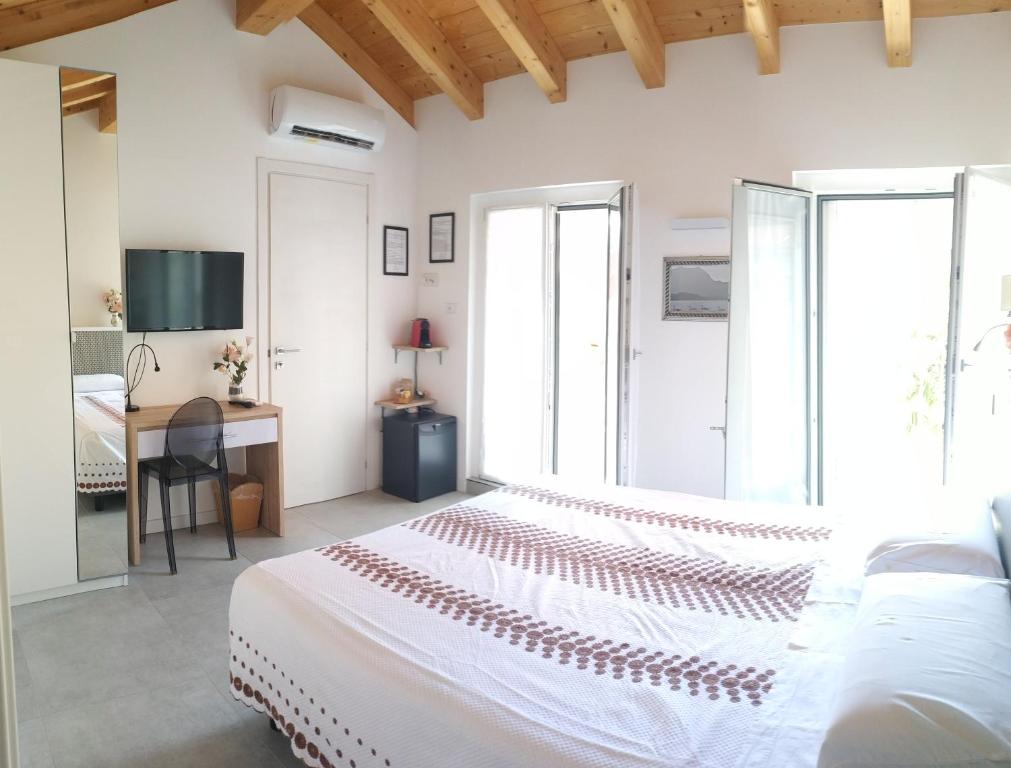 una camera bianca con letto e scrivania di sweet homes a Lecco