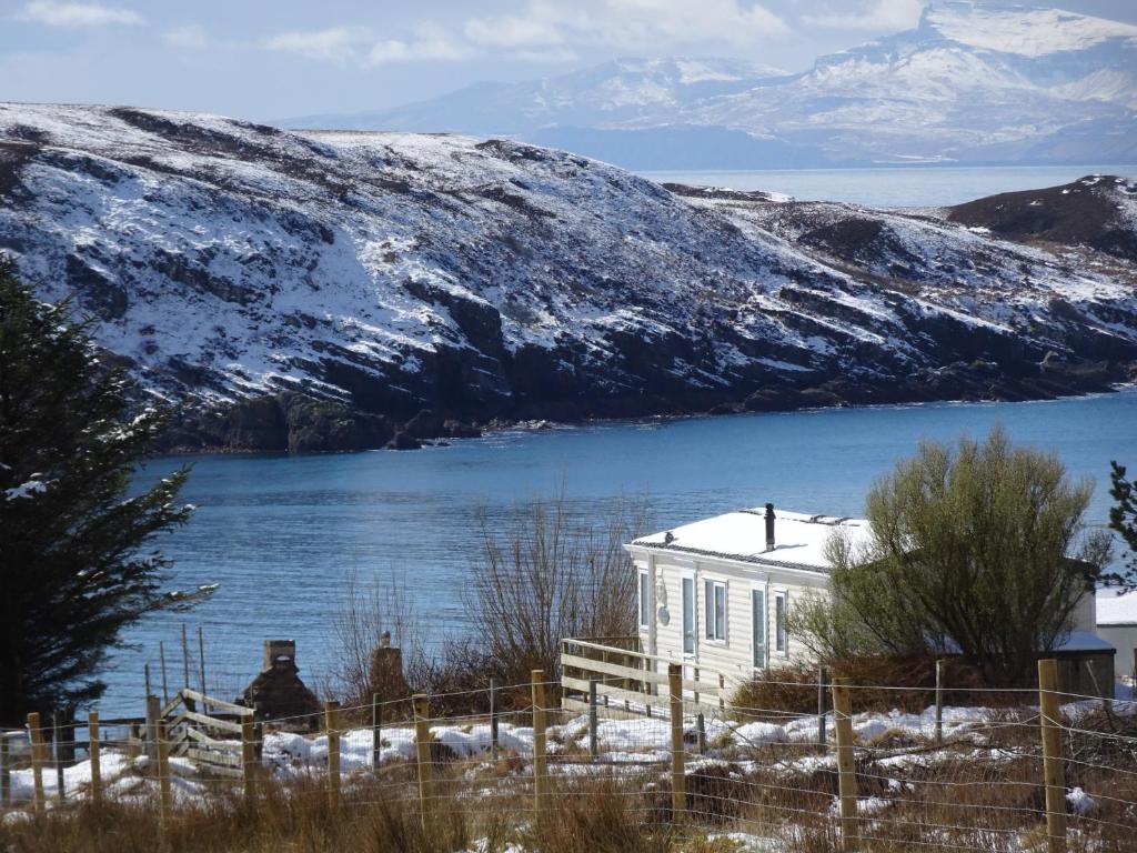 a house on the shore of a body of water at Asgard in Big Sand