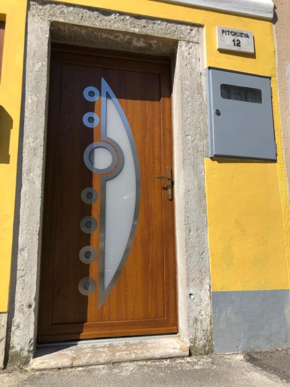 a wooden door with a sign on it at Apartment Vladka PARK in Izola