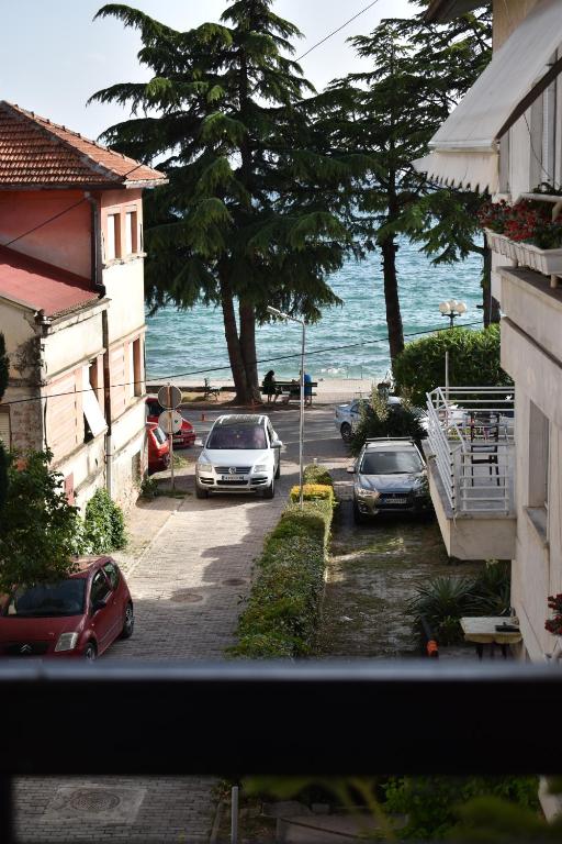 a view of a street with cars parked on the beach at Apartments Argiroski in Ohrid