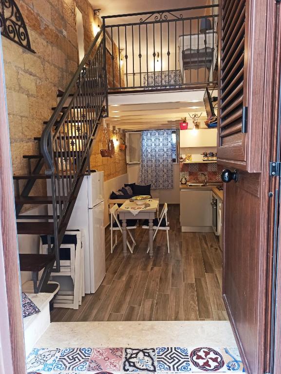 a staircase in a tiny house with a table at Casa Liò in Santa Flavia