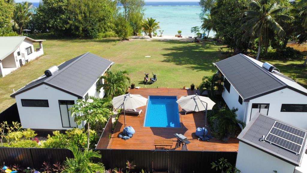 an aerial view of a house with a swimming pool and the ocean at Abera's Aitutaki Villas in Arutanga
