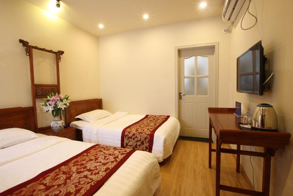 Postel nebo postele na pokoji v ubytování Beijing Yue Bin Ge Courtyard Hotel