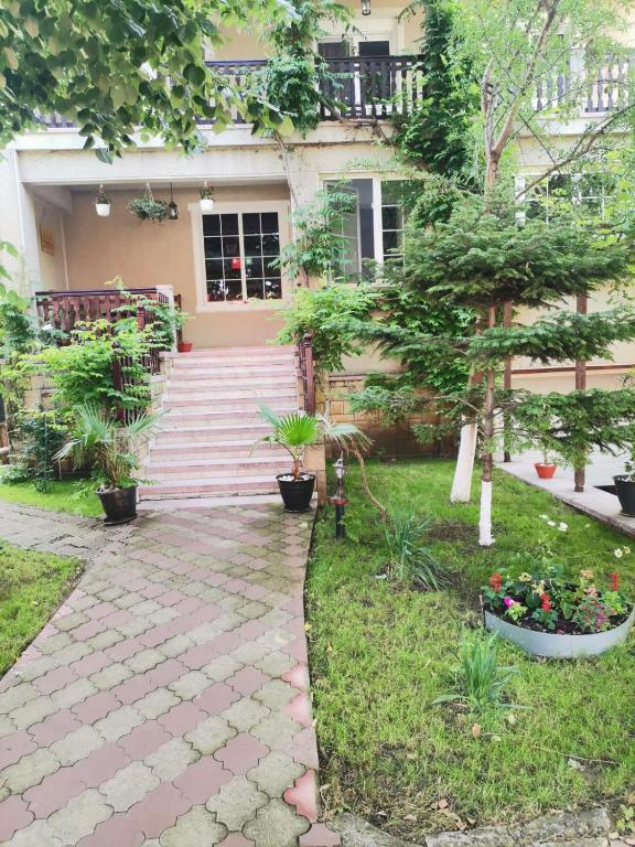a house with a walkway in front of it at Vila Cristal Costinesti in Costinesti
