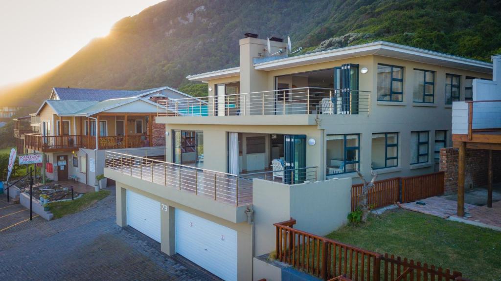 a large house with a mountain in the background at No 73 Top Eersterivierstrand in Eersterivierstrand
