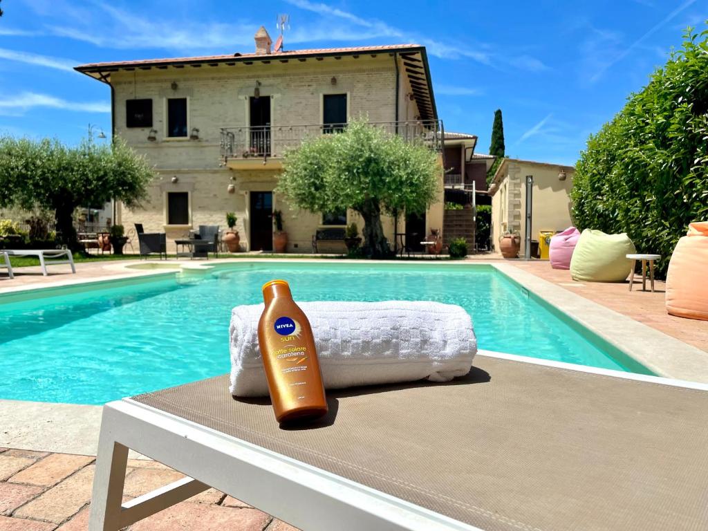 una bottiglia di shampoo seduta su un tavolo accanto alla piscina di Domus Angeli ad Assisi