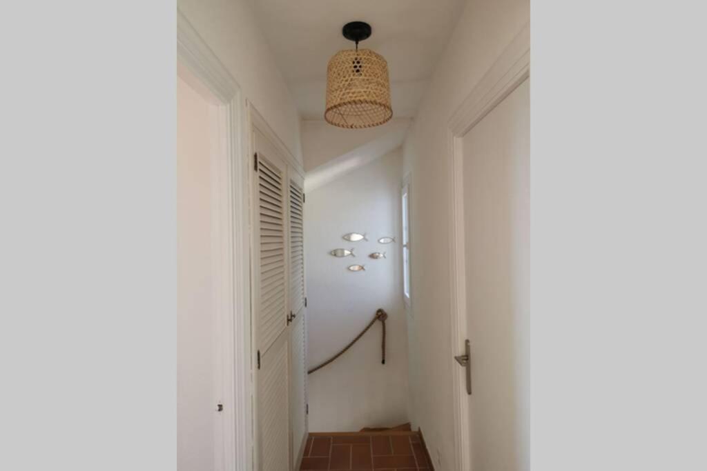 a hallway with a white room with a ceiling at V. Lona: beautiful duplex with a stunning seaview in Es Mercadal
