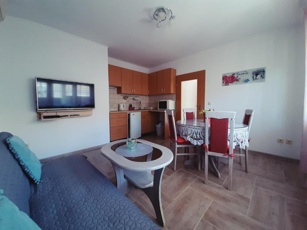 a living room with a kitchen and a dining room at Apartment Luna in Trogir