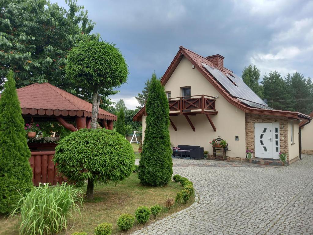 a small house with a pavilion next to at Dom całoroczny Wczasy jak Marzenie in Ruciane-Nida