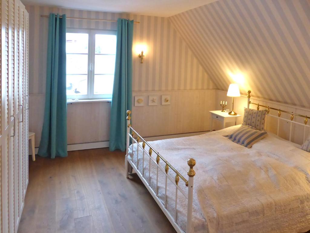 a bedroom with a large bed and a window at Stilvoll Urlaub machen! in Dudenhofen