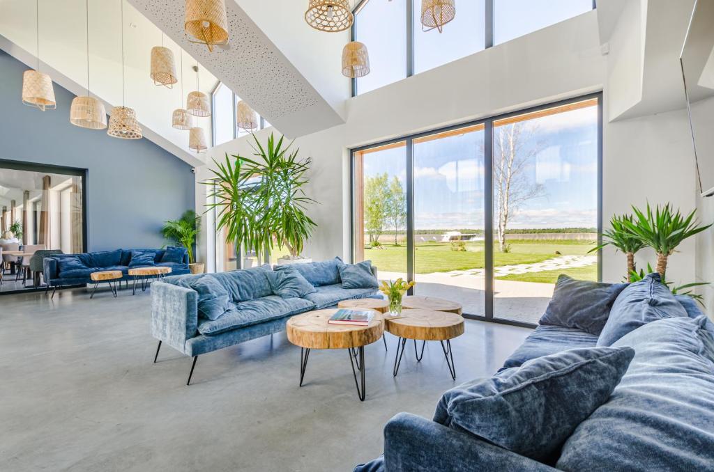 a living room with blue couches and a table at Kite Marina Sarbsk in Sarbsk