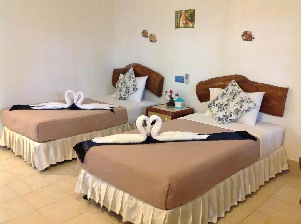 Postel nebo postele na pokoji v ubytování Ruan Mai San Ngam Resort - SHA Plus