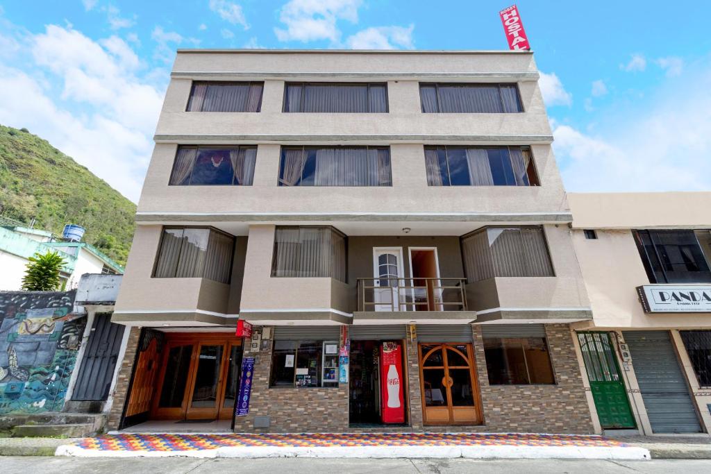 a building on the corner of a street at Hostal Rossy in Baños