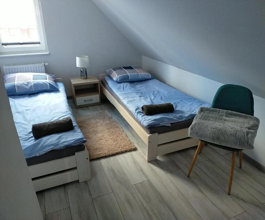 En eller flere senge i et værelse på Kaszubski Zakątek