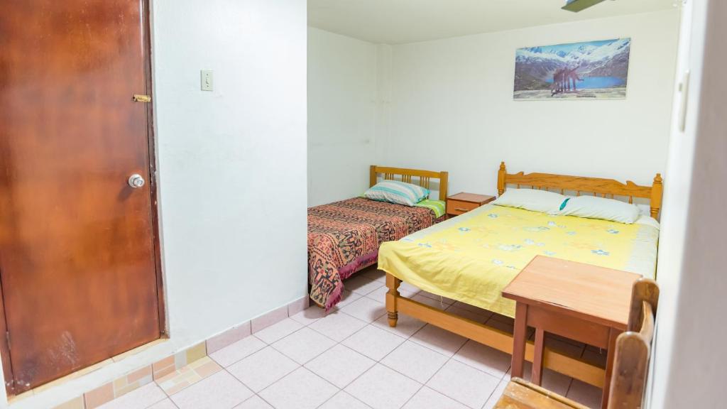 Postel nebo postele na pokoji v ubytování Hostal Ñaña