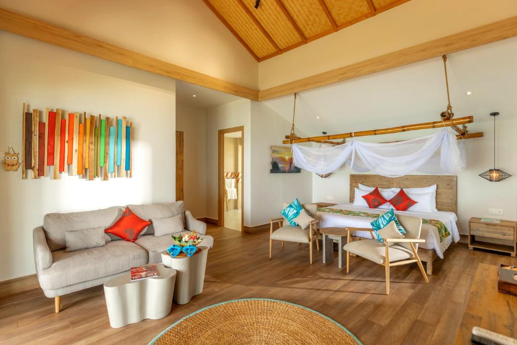 a living room with a couch and a bed at Pax Ana Doc Let Resort & Spa in Ninh Hòa
