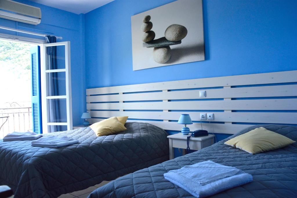 Postel nebo postele na pokoji v ubytování Hotel Nostos