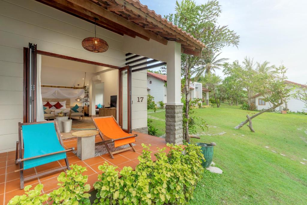 a patio with two chairs and a table at Pax Ana Doc Let Resort & Spa in Ninh Hòa