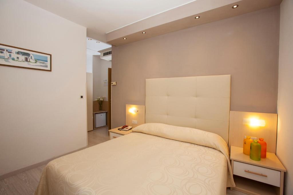 Postel nebo postele na pokoji v ubytování Hotel Torino