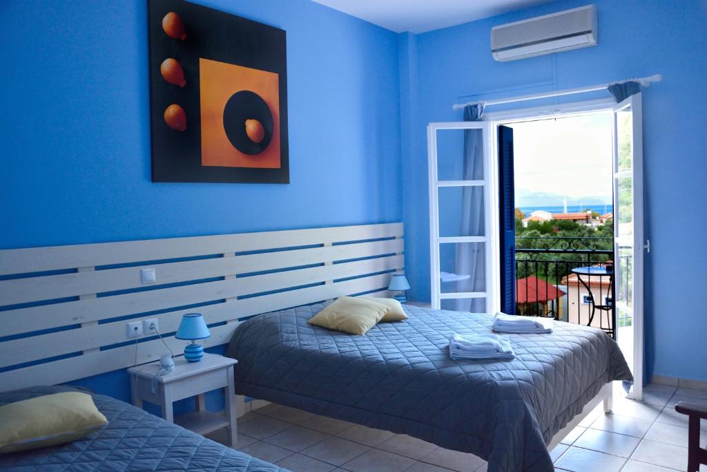 Postel nebo postele na pokoji v ubytování Hotel Nostos