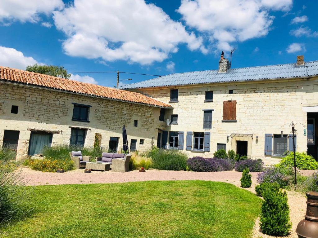 a large white brick building with a yard at Maison de Lavande in Ranton