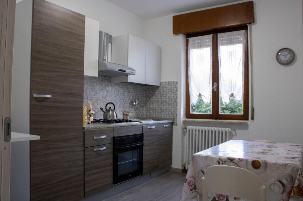 a kitchen with a sink and a stove top oven at La tana dello zio Gio in Endine Gaiano