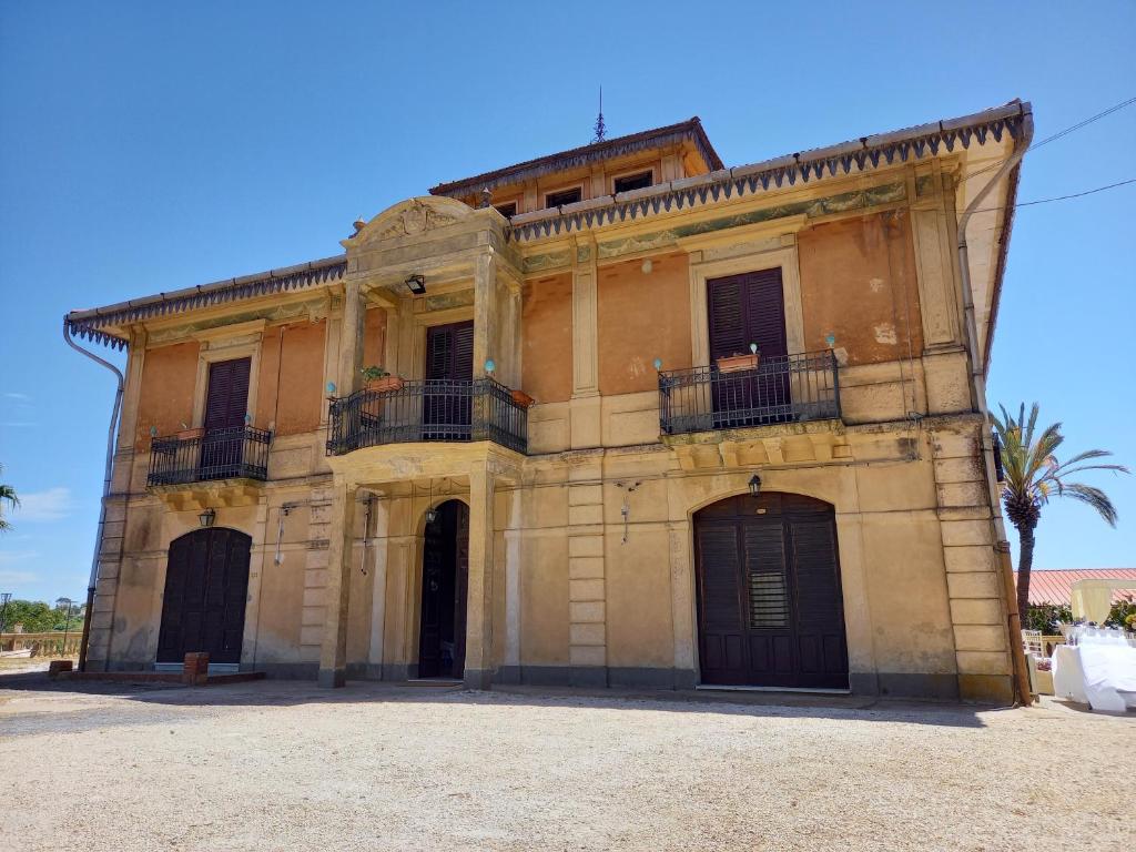 a large building with two balconies on top of it at Casolare del Toscano Country Rooms in Caltagirone