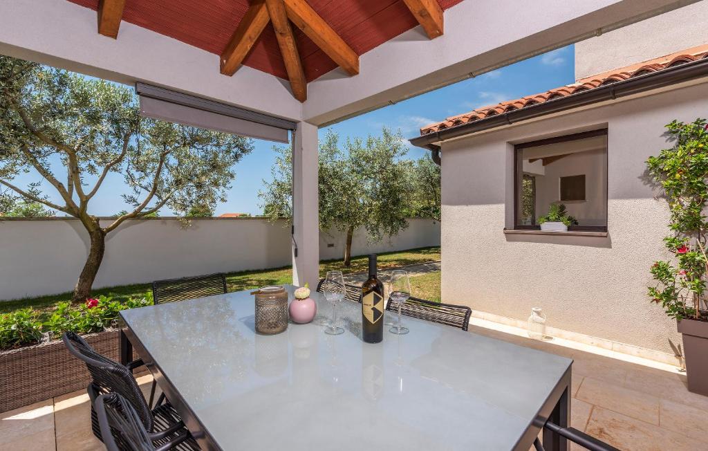 a patio with a table and a large window at Apartment Maria in Vodnjan