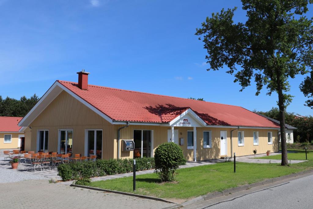 a building with a red roof on a street at Ellen Hotel in Flensburg