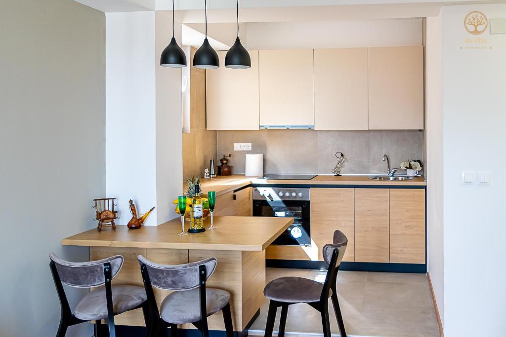 a kitchen with a wooden table and chairs at La Vita Apartment 2 in Ohrid