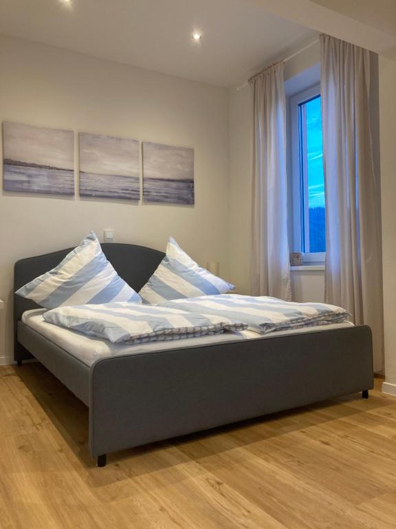 a large bed in a room with a window at Apartment Hallenbach in Zell an der Mosel