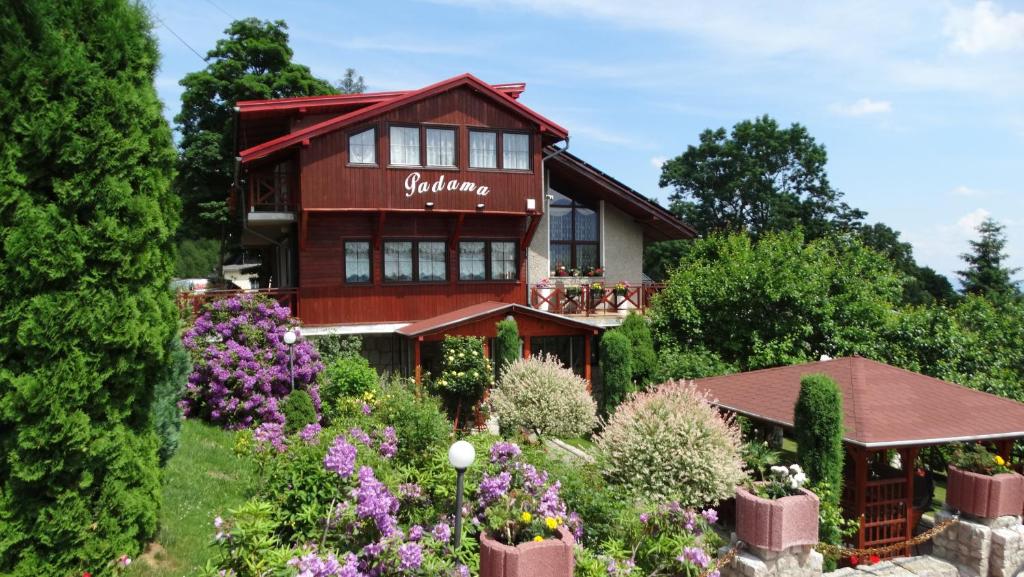 a house with flowers in front of it at Willa Padama in Szklarska Poręba