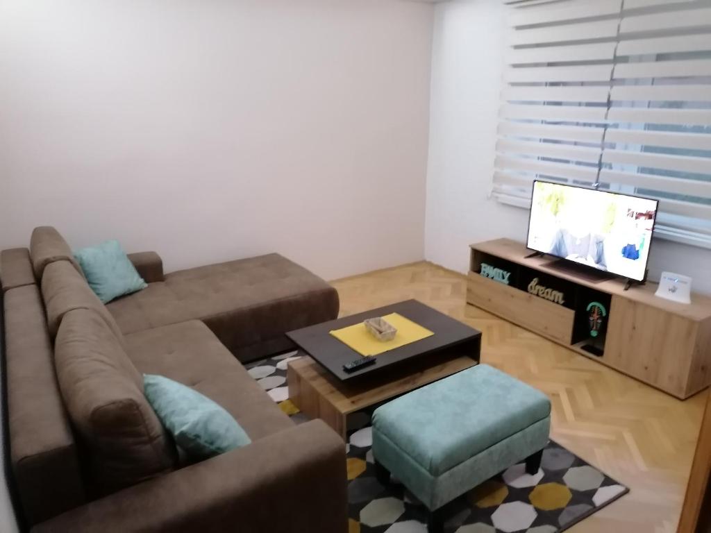 a living room with a couch and a coffee table at Apartman Bogdanović Sokobanja in Soko Banja