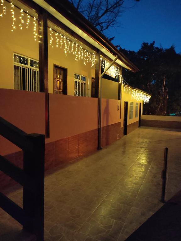 a building with christmas lights on the side of it at Pousada Sossego da Vila - Trindade Paraty in Trindade