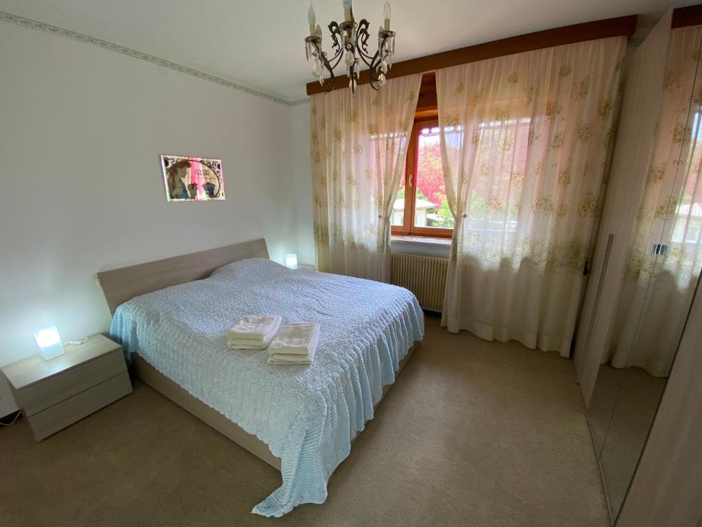 a bedroom with a white bed and a window at Discover Italy in Tignes