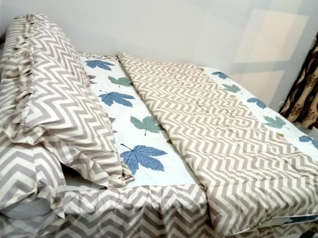 a bed with pillows on it in a room at Villa Lembang Syariah near park & Zoo in Lembang