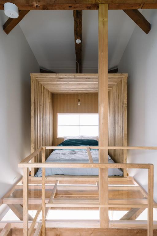 Postel nebo postele na pokoji v ubytování koume no tonari コウメノトナリ