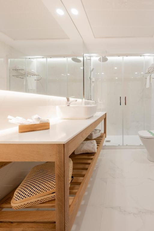 a white bathroom with a sink and a shower at Toboso Apar - Turis in Nerja