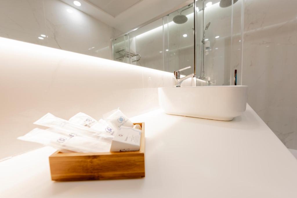 a white bathroom with a sink and a mirror at Toboso Apar - Turis in Nerja