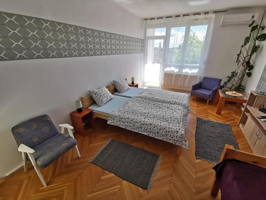 a living room with two beds and a couch at Acceptus Domus in Szombathely