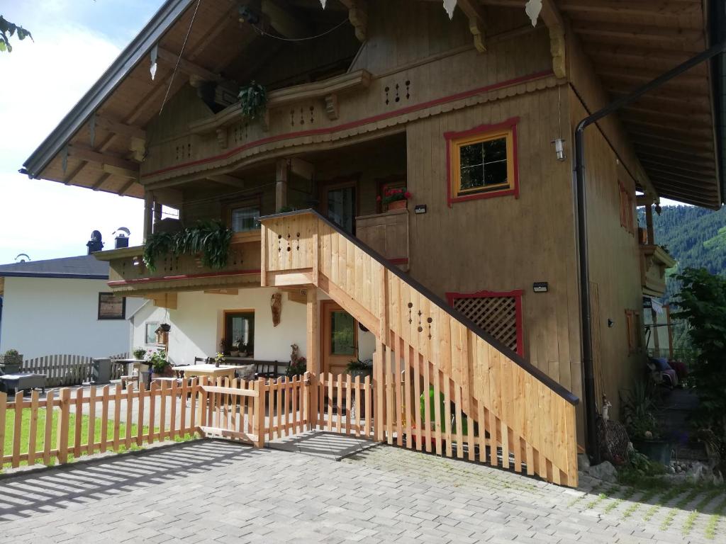 a house with a wooden staircase leading up to it at Ferienwohnung Spitaler Unterkofler in Hippach