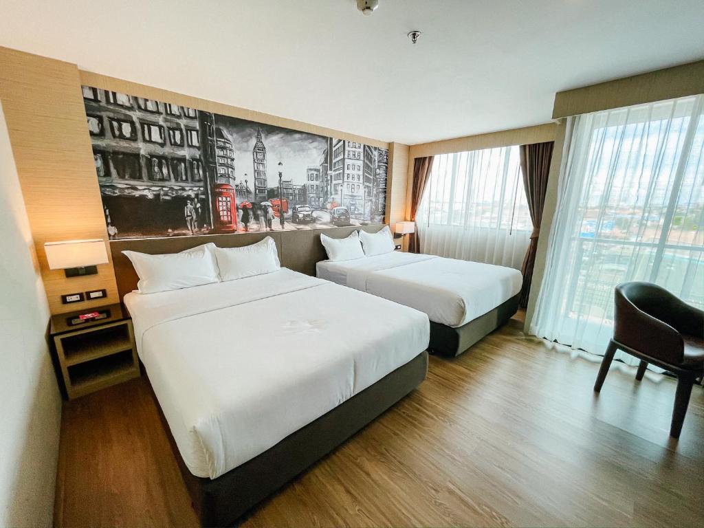 Postel nebo postele na pokoji v ubytování GLOW Pattaya
