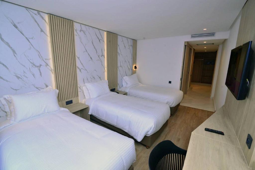Postel nebo postele na pokoji v ubytování Rihab Hotel
