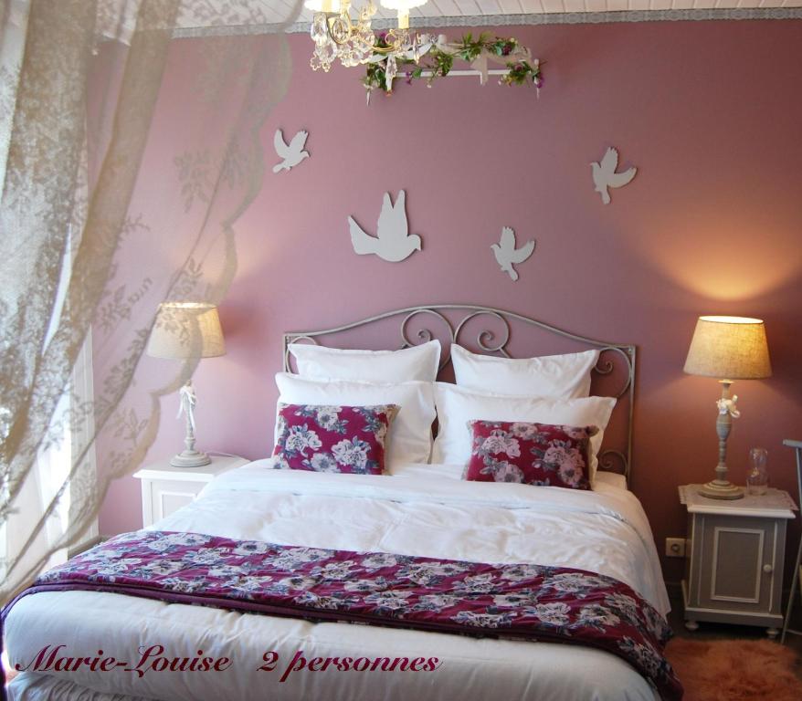 a bedroom with a bed with butterflies on the wall at Gite Riquewihr "C'est Beau la Vie Alsace" in Riquewihr